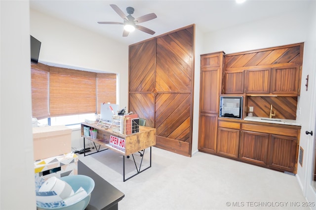 office space featuring ceiling fan and light colored carpet