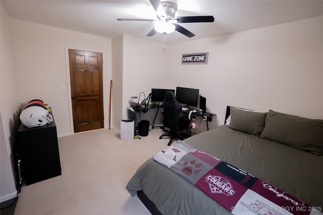 bedroom featuring carpet flooring, an office area, and a ceiling fan