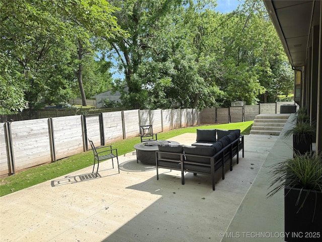 view of patio featuring an outdoor living space with a fire pit and a fenced backyard