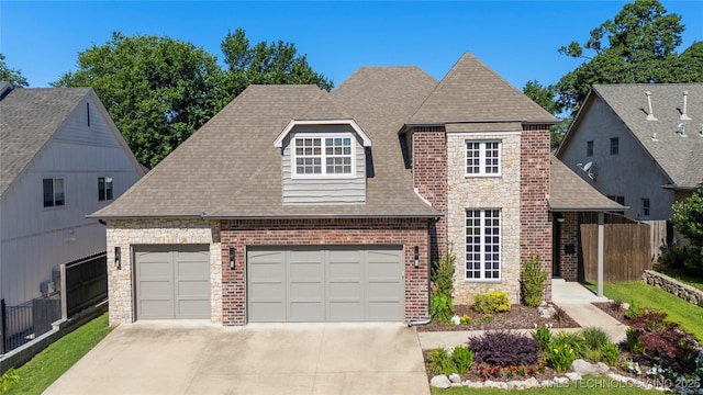 3528 S Wheeling Ave, Tulsa, OK 74105 - view of front of home with roof with shingles, concrete driveway, brick siding, and stone siding