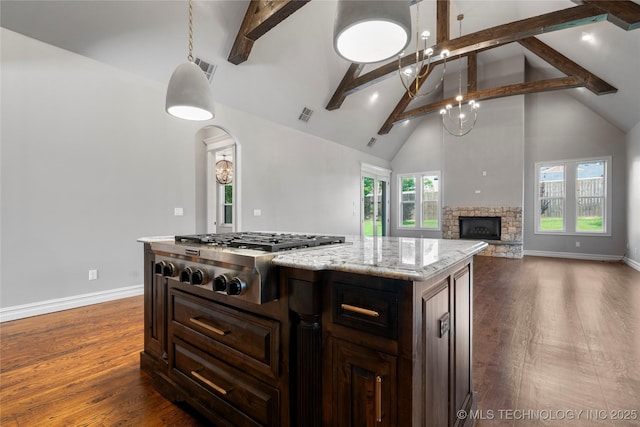 3528 S Wheeling Ave, Tulsa, OK 74105 - kitchen with stainless steel gas stovetop, high vaulted ceiling, beamed ceiling, dark wood finished floors, and a fireplace