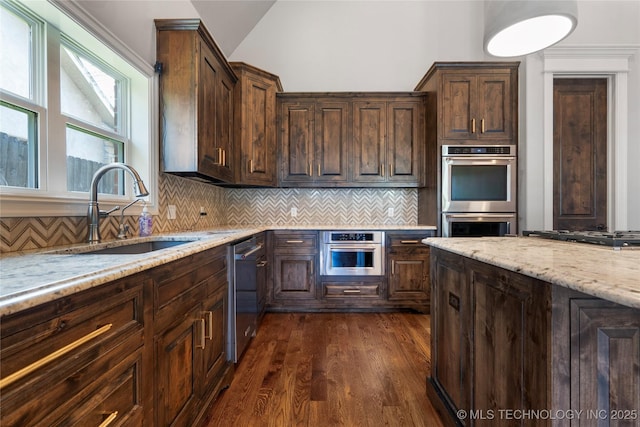 3528 S Wheeling Ave, Tulsa, OK 74105 - kitchen with stainless steel appliances, light stone countertops, dark wood-type flooring, dark brown cabinets, and vaulted ceiling