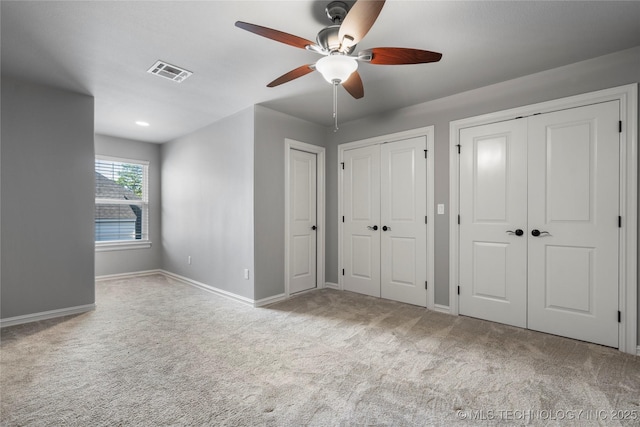 3528 S Wheeling Ave, Tulsa, OK 74105 - unfurnished bedroom with two closets, carpet, and ceiling fan