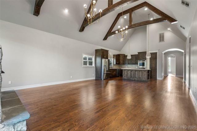 3528 S Wheeling Ave, Tulsa, OK 74105 - unfurnished living room with high vaulted ceiling, arched walkways, a chandelier, beamed ceiling, and dark wood finished floors
