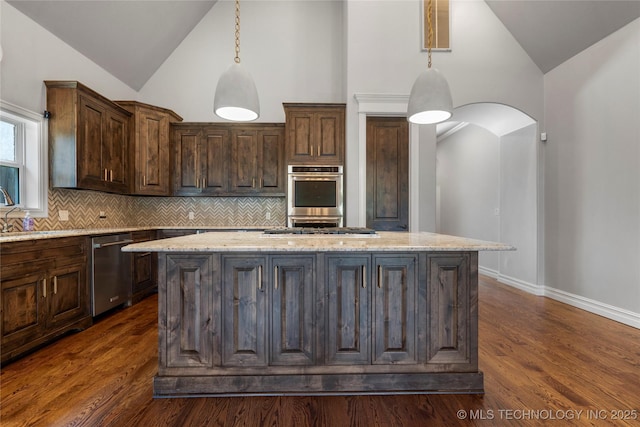 3528 S Wheeling Ave, Tulsa, OK 74105 - kitchen featuring stainless steel appliances, backsplash, a center island, light stone countertops, and high vaulted ceiling