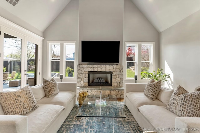 3528 S Wheeling Ave, Tulsa, OK 74105 - living room featuring high vaulted ceiling, a fireplace, healthy amount of natural light, and wood finished floors