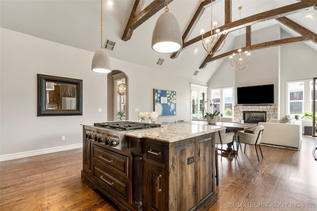 3528 S Wheeling Ave, Tulsa, OK 74105 - kitchen featuring high vaulted ceiling, stainless steel gas stovetop, beamed ceiling, healthy amount of natural light, and wood finished floors