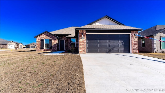 ranch-style house with a front yard, roof with shingles, concrete driveway, brick siding, and a garage