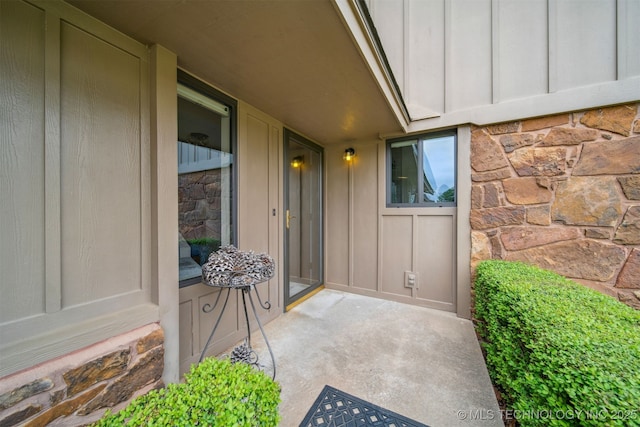 13542 N 155th E Ave, Collinsville, OK 74021 - doorway to property with stone siding and board and batten siding