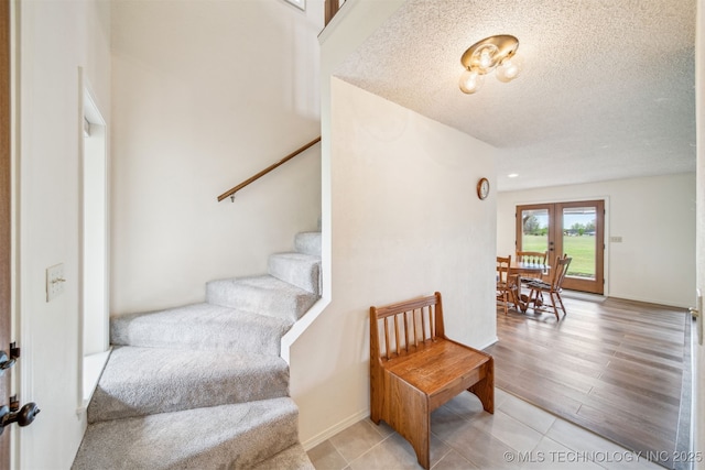 13542 N 155th E Ave, Collinsville, OK 74021 - staircase with a textured ceiling and french doors