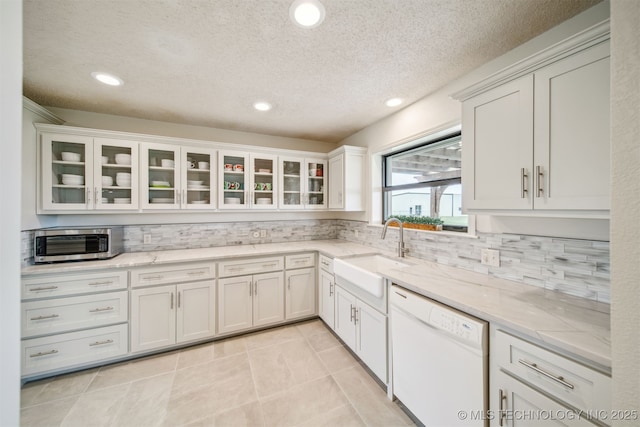 13542 N 155th E Ave, Collinsville, OK 74021 - kitchen featuring dishwasher, decorative backsplash, stainless steel microwave, light stone counters, and recessed lighting