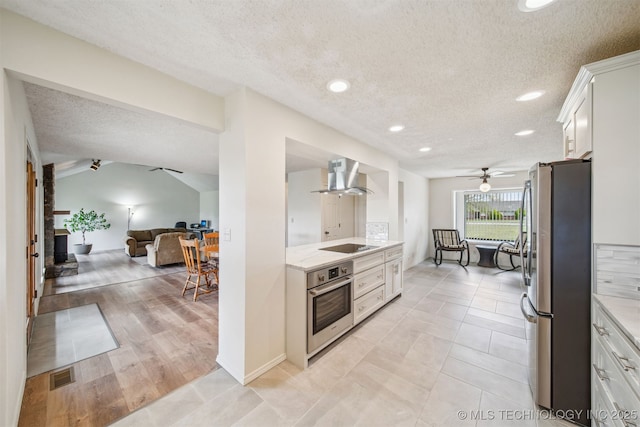 13542 N 155th E Ave, Collinsville, OK 74021 - kitchen featuring stainless steel appliances, wall chimney exhaust hood, ceiling fan, a textured ceiling, and open floor plan