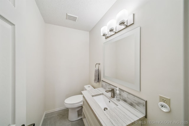 13542 N 155th E Ave, Collinsville, OK 74021 - bathroom featuring a textured ceiling, vanity, and tile patterned flooring