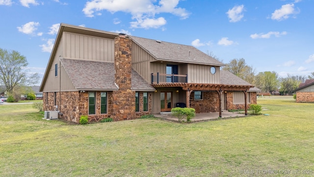 13542 N 155th E Ave, Collinsville, OK 74021 - rear view of property featuring stone siding, a patio, a lawn, board and batten siding, and a chimney