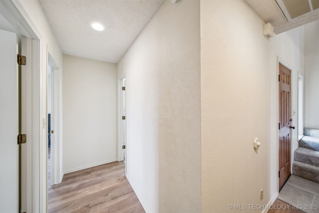 13542 N 155th E Ave, Collinsville, OK 74021 - hallway featuring light wood-style floors, a textured ceiling, stairway, and recessed lighting