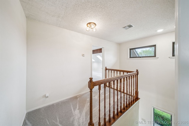 13542 N 155th E Ave, Collinsville, OK 74021 - corridor with an upstairs landing, a textured ceiling, and carpet