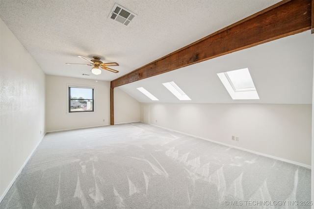 13542 N 155th E Ave, Collinsville, OK 74021 - additional living space with a skylight, lofted ceiling, light colored carpet, a textured ceiling, and ceiling fan