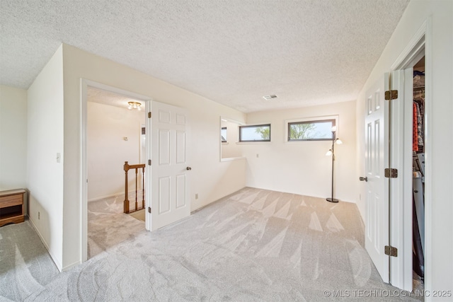 13542 N 155th E Ave, Collinsville, OK 74021 - unfurnished bedroom with carpet floors and a textured ceiling