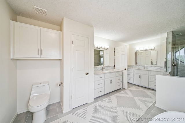13542 N 155th E Ave, Collinsville, OK 74021 - bathroom featuring vanity, a shower stall, a textured ceiling, and tile patterned flooring