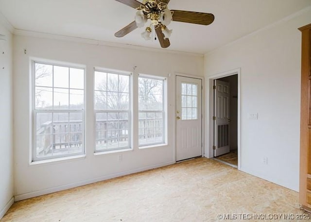 unfurnished room featuring baseboards, ornamental molding, and a ceiling fan