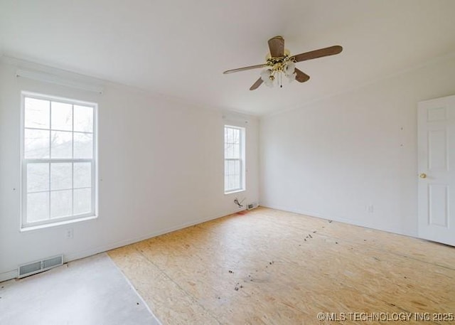 empty room featuring visible vents and a ceiling fan