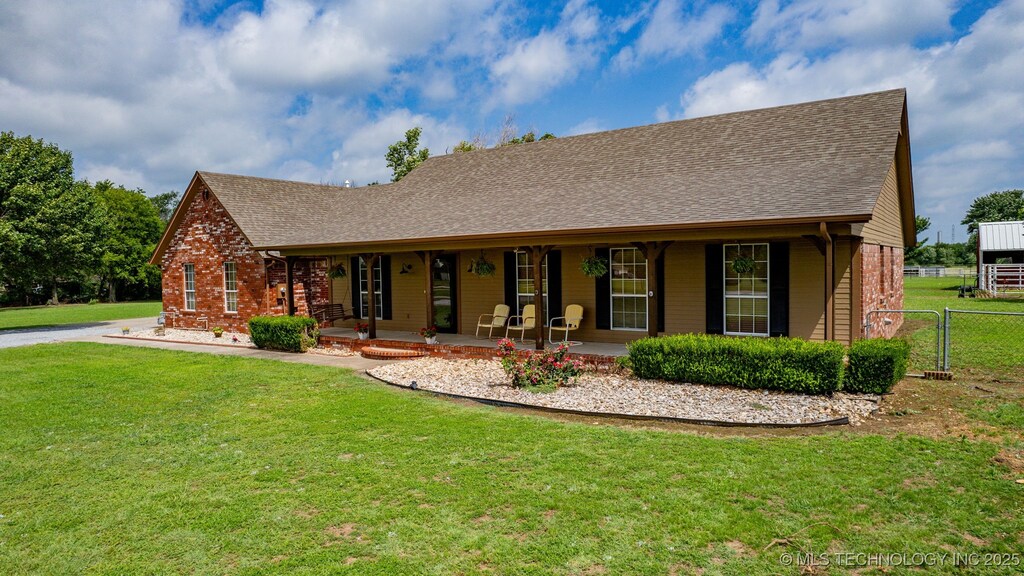 16355 E 590th Rd, Inola, OK 74036 - rear view of house with a yard, covered porch, fence, and brick siding