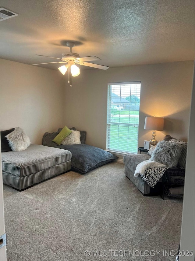 60 S Kaylee Rd, Calera, OK 74730 - carpeted bedroom featuring a textured ceiling and ceiling fan