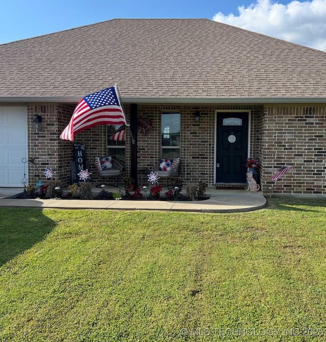 60 S Kaylee Rd, Calera, OK 74730 - doorway to property with brick siding, a shingled roof, a yard, and a garage
