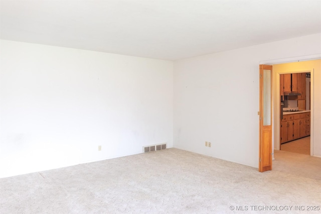 carpeted empty room with visible vents