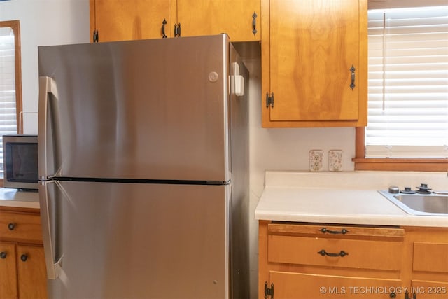 kitchen featuring light countertops, a sink, and appliances with stainless steel finishes