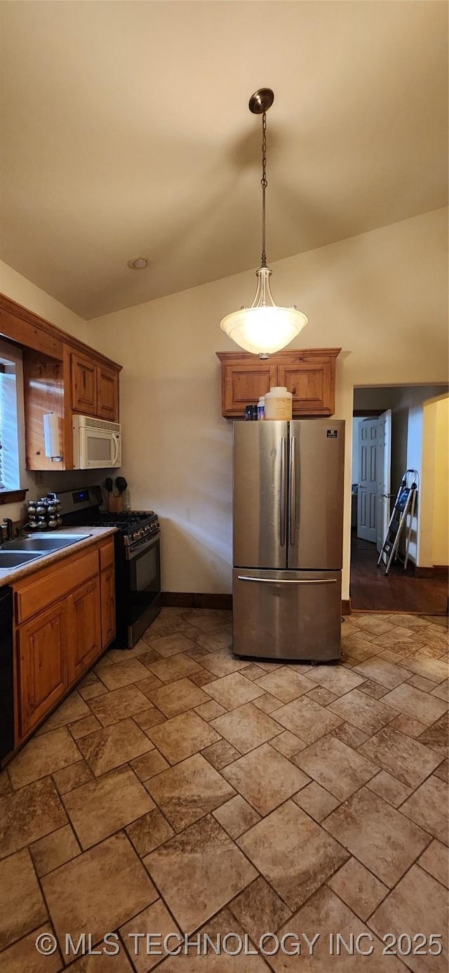 4100 Sally Brown Rd, Muskogee, OK 74403 - kitchen with stainless steel appliances, stone finish flooring, and brown cabinetry