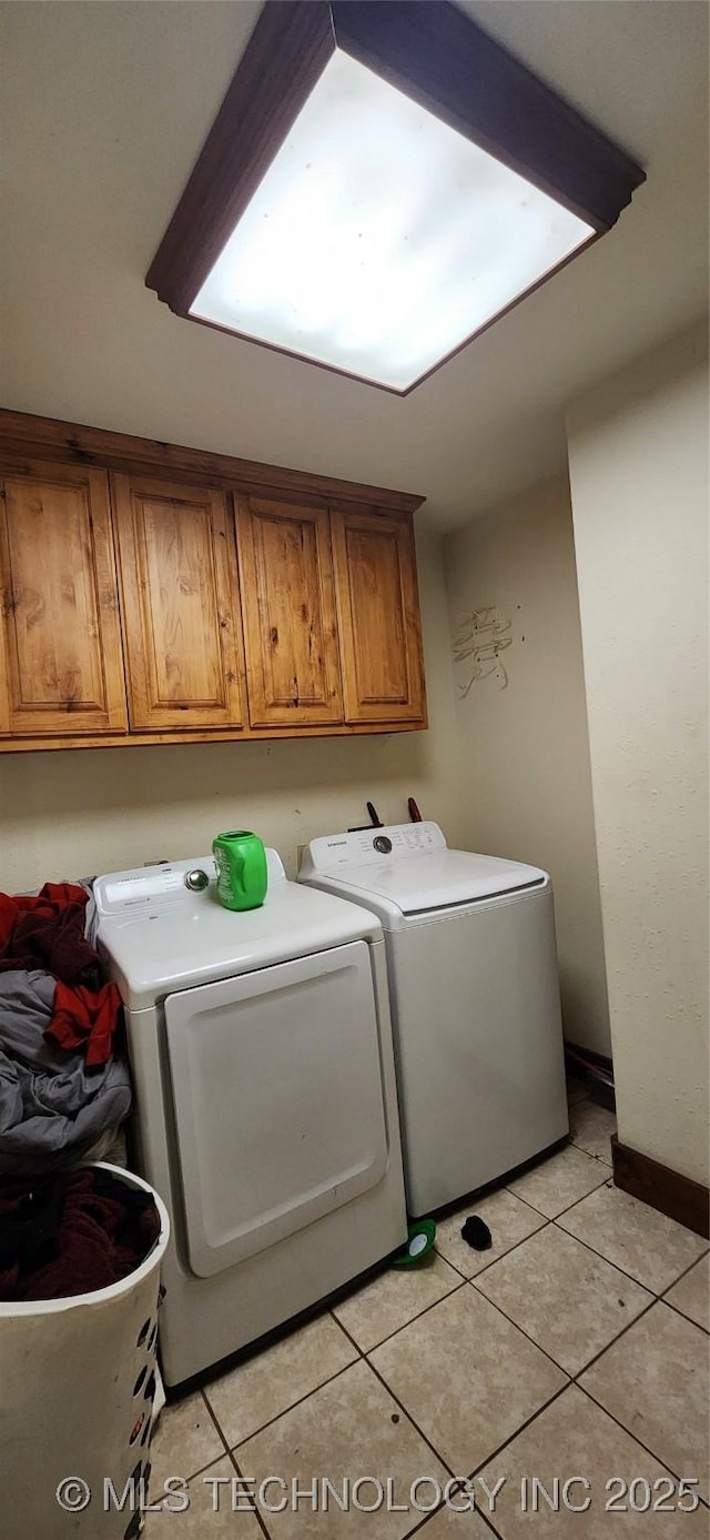 4100 Sally Brown Rd, Muskogee, OK 74403 - washroom featuring washing machine and dryer, cabinet space, and light tile patterned floors