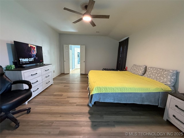 bedroom with lofted ceiling, ceiling fan, and wood finished floors