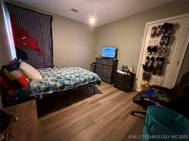 bedroom featuring visible vents and light wood-style flooring