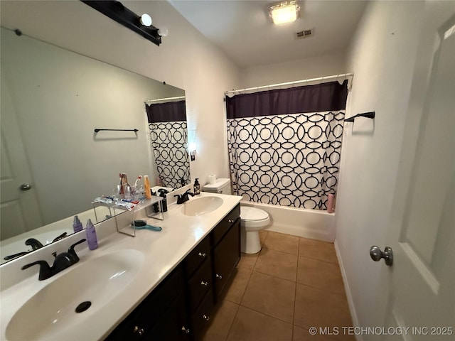 bathroom featuring visible vents, a sink, tile patterned floors, and toilet