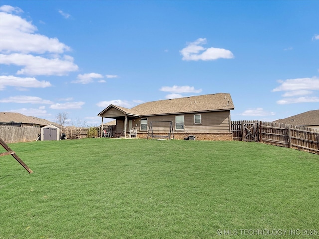 back of house with a lawn, a fenced backyard, an outdoor structure, and a shed