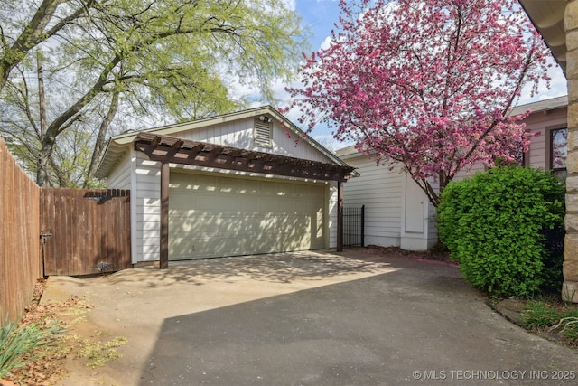 view of front of house with a garage and fence