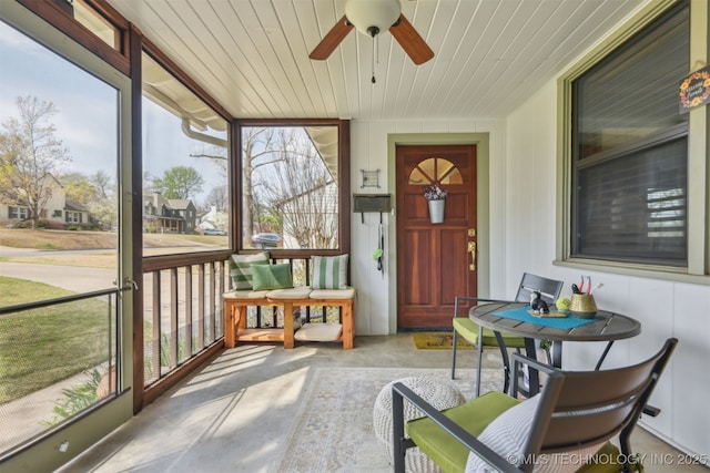 sunroom featuring a ceiling fan