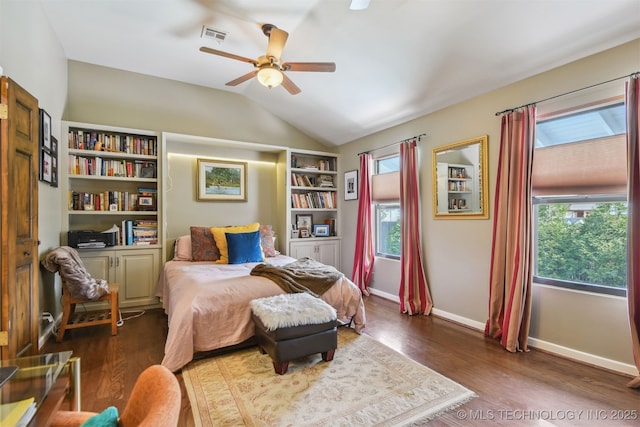 bedroom featuring visible vents, baseboards, ceiling fan, wood finished floors, and lofted ceiling