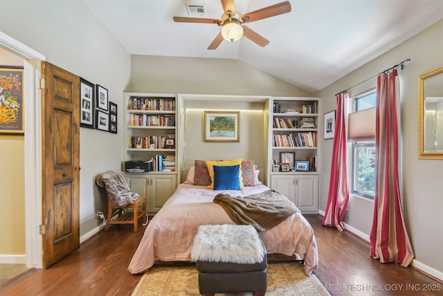 bedroom featuring baseboards, visible vents, wood finished floors, and vaulted ceiling