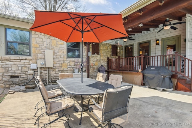 view of patio with a grill, ceiling fan, and outdoor dining area