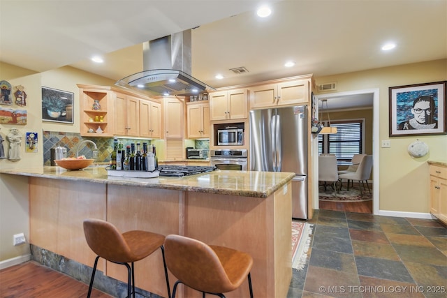 kitchen with stainless steel appliances, light brown cabinetry, light stone countertops, a peninsula, and ventilation hood
