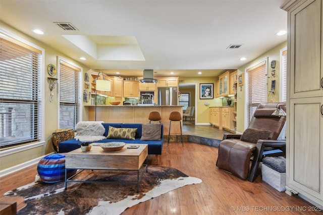 living area with visible vents, recessed lighting, and dark wood finished floors