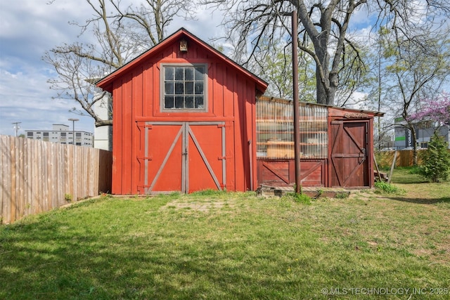 view of outbuilding with an outbuilding and fence