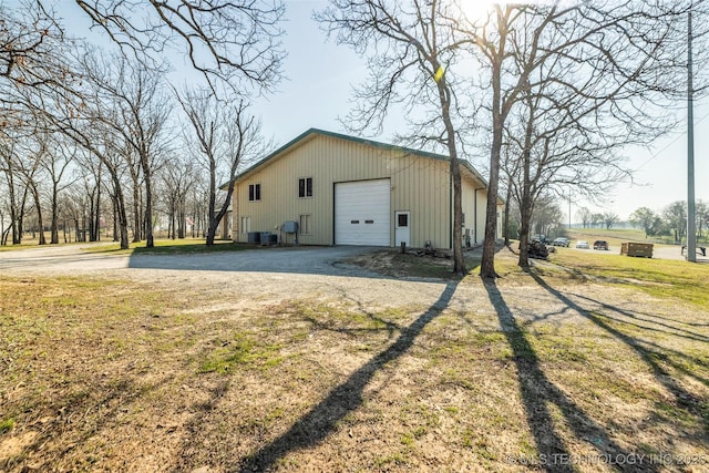 view of outbuilding with driveway and an outbuilding