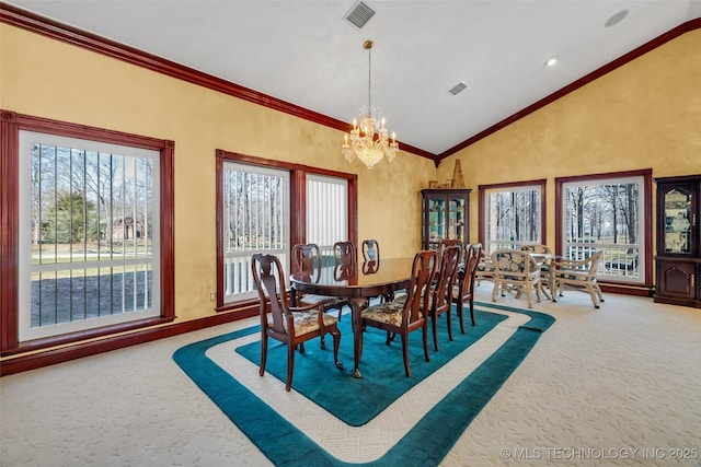carpeted dining space with high vaulted ceiling, crown molding, a chandelier, and visible vents