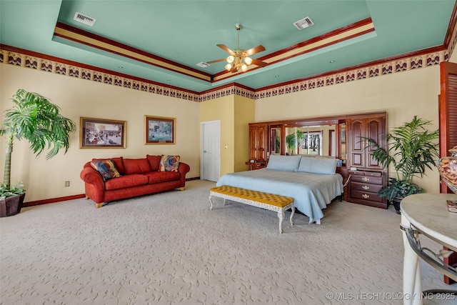 bedroom featuring a raised ceiling, carpet, baseboards, and visible vents