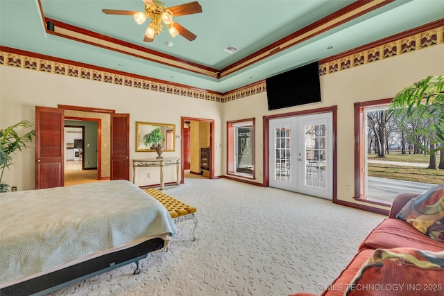 carpeted bedroom featuring a tray ceiling, french doors, access to outside, a high ceiling, and visible vents