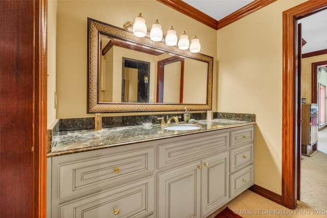 bathroom with baseboards, vanity, and ornamental molding