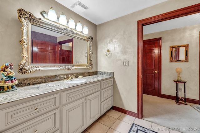 bathroom featuring tile patterned floors, vanity, baseboards, and visible vents